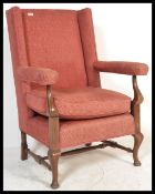 A 19th Century Georgian style wingback armchair, t