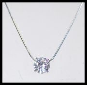 A sterling silver necklace having a large CZ white