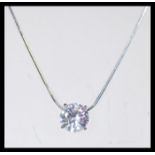 A sterling silver necklace having a large CZ white