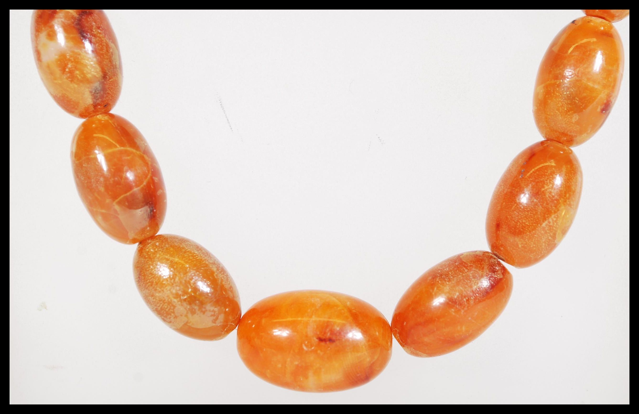 A vintage amber / faux amber Chinese prayer bead n