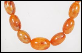 A vintage amber / faux amber Chinese prayer bead n