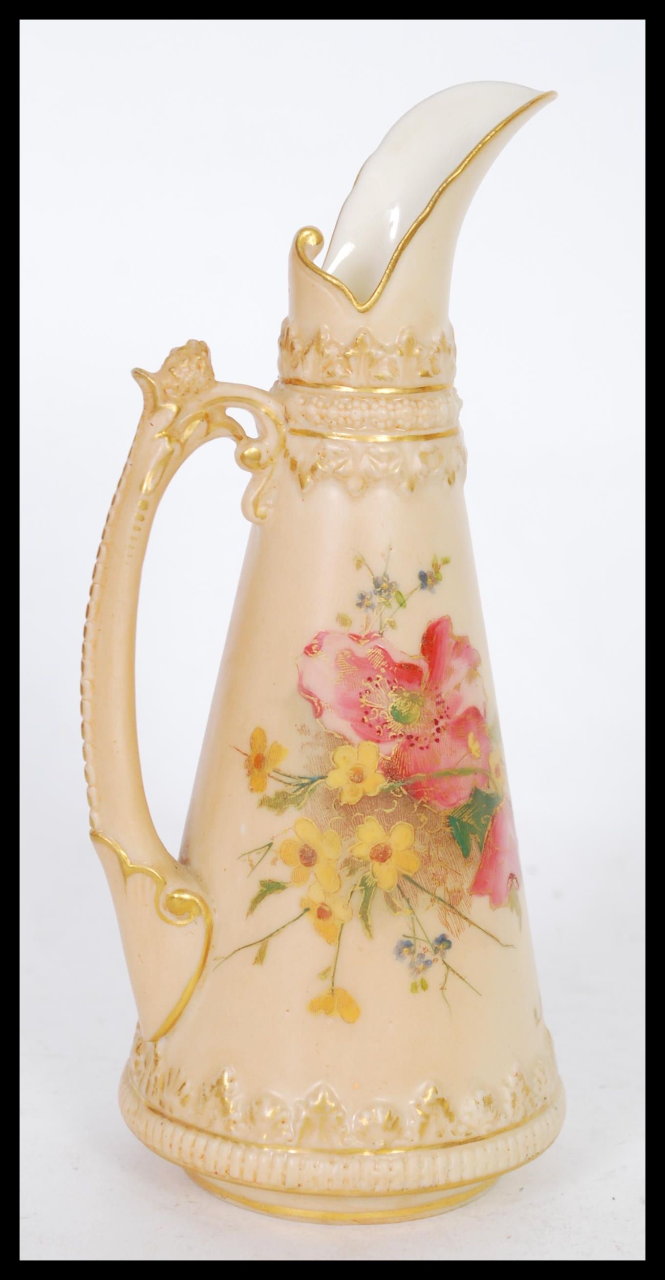 A early 20th Century Royal Worcester blush ivory jug of tapering form with hand painted floral