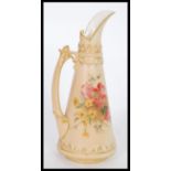 A early 20th Century Royal Worcester blush ivory jug of tapering form with hand painted floral