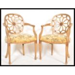 A pair of  cartwheel back Chippendale gilt mahogany dining chairs. Each with overstuffed seats