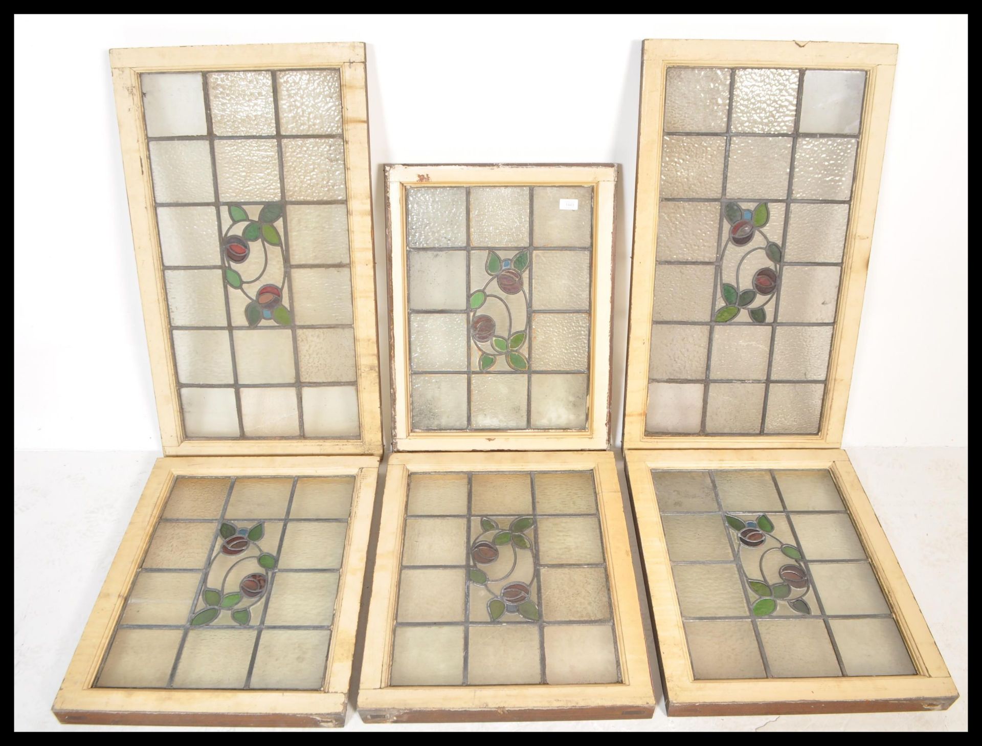 A set of early 20th century painted pine leaded and stained glass windows. Painted wooden