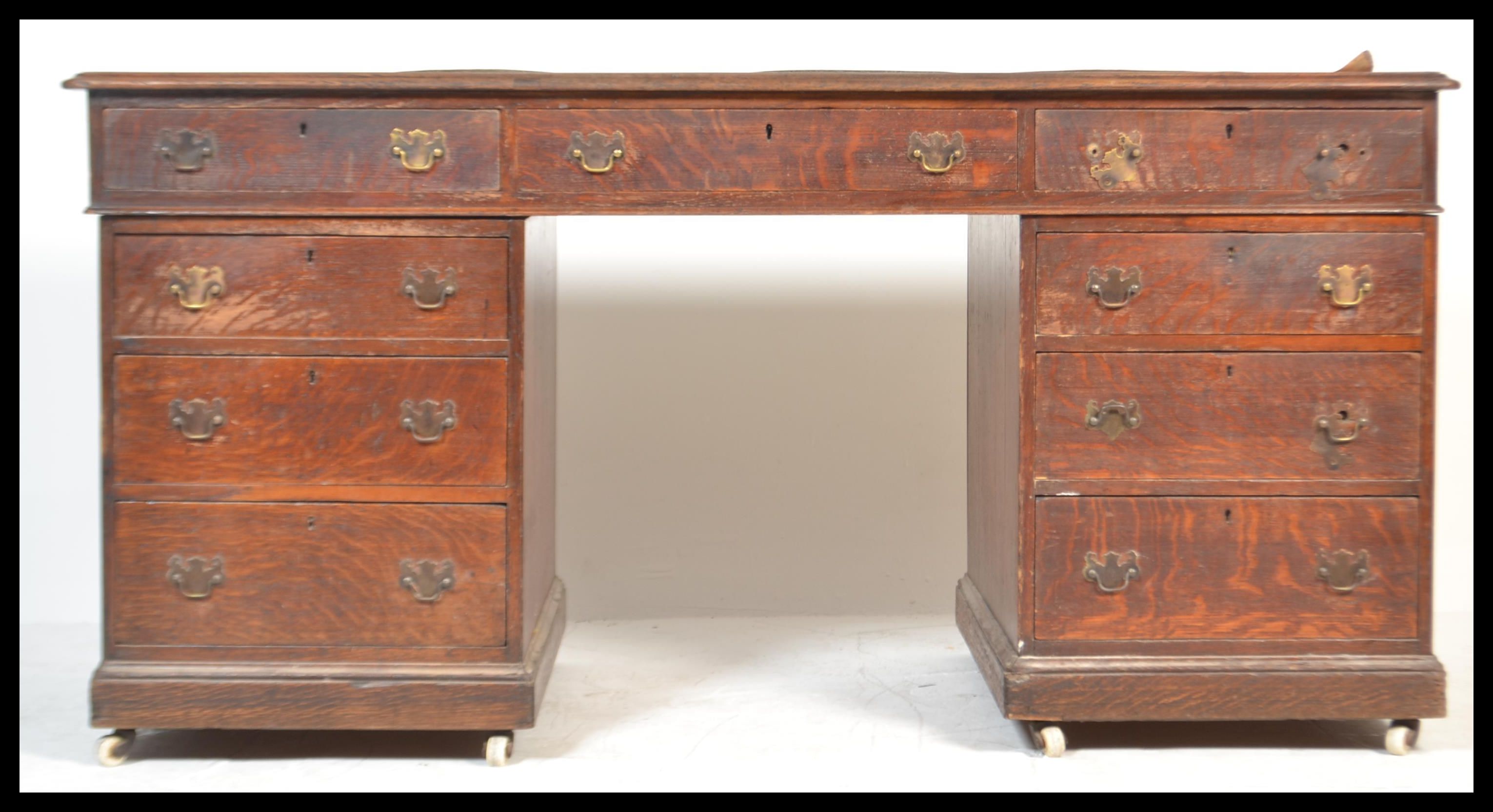 A 19th Century Victorian large oak twin pedestal desk having two banks of drawers having brass
