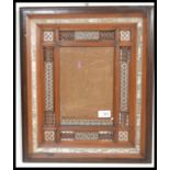A late 19th / early 20th Indian Anglo Colonial picture frame, the carved hardwood wooden frame