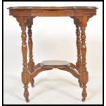 A 19th Century Victorian centre table having a round top with shaped edges, raised on four turned