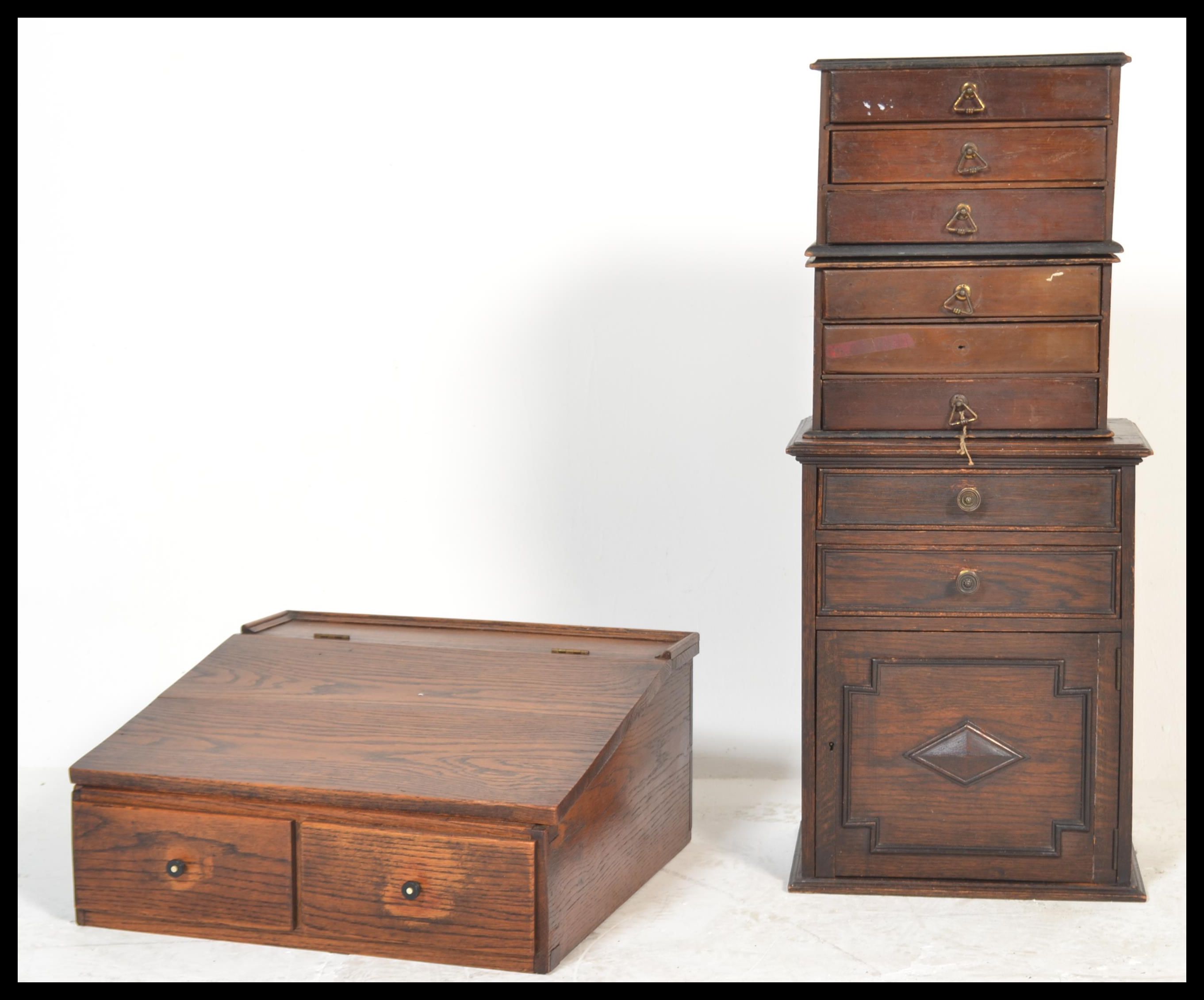 A group of early 20th Century industrial furniture to include a writing slope, pair of specimen