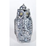 A silver plated sovereign vase with the form of an owl having yellow glass eyes with bale hoop to