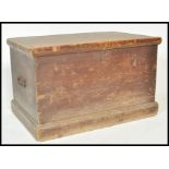 A 19th Century pine trunk coffer chest box having wrought iron drop handles and having painted