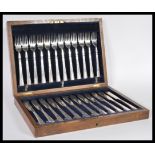 A vintage early 20th Century silver plated canteen of cutlery in oak case consisting of twelve