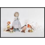 A collection of ceramic figurines to include two Beswick style Blanc De Chine white glazed china