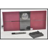 A retro Bang & Olufsen Beosound 2000 CD Cassette Radio Tuner with burgundy coloured speakers.