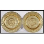 A pair of reproduction 19th Century gilt bronze heavy wall chargers of circular form having relief