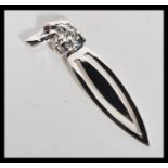 A sterling silver bookmark clip in the form of a dogs head with red stone set eye.