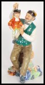 A 20th Century Royal Doulton ceramic figurine entitled the Puppet Maker / Puppetmaker HN2253