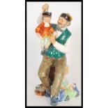 A 20th Century Royal Doulton ceramic figurine entitled the Puppet Maker / Puppetmaker HN2253