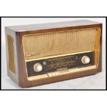 A vintage 20th Century walnut cased Grundig AM / FM valve radio. Model No 3028. Dials and controls