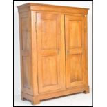 A 19th century French provincial walnut triple armoire. The upright body with twin full length panel