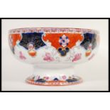 A late 19th Century Victorian Staffordshire Imari bowl raised on circular foot with transfer printed