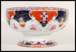 A late 19th Century Victorian Staffordshire Imari bowl raised on circular foot with transfer printed