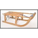 An early 20th Century childs sleigh raised on bowed rockers with iron bands and plank top. Measures: