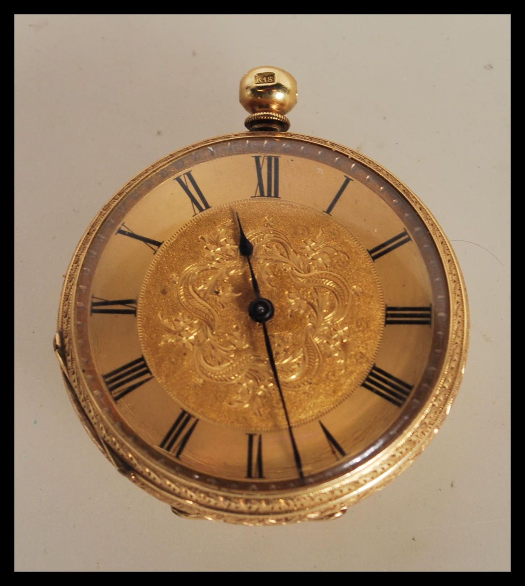 An early 20th Century continental fob open face pocket watch within a stamped 18k gold case,