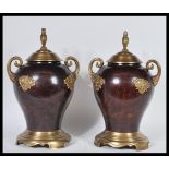 A pair of 20th Century bronze and ormolu urn vases having bulbous bodies with scrolled gilt