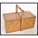 A 20th Century retro concertina sewing work box with metamorphic scissor action, inlaid detailing to