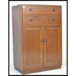 A vintage early 20th Century circa 1930's mahognay tallboy, chest cupboard two long drawers over