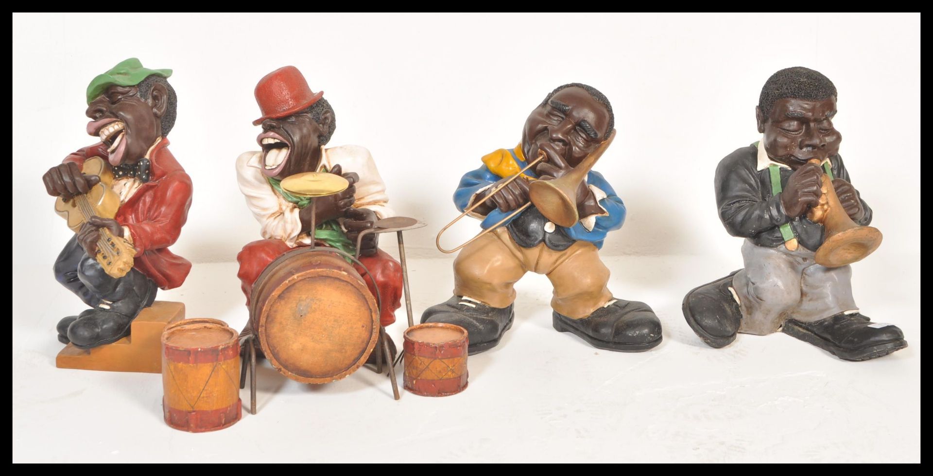 A retro 20th century resin cast and painted negro jazz musician band comprising 4 pieces to