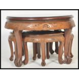 A 20th Century Carved Chinese hardwood coffee table / nest of tables, intricately carved to the