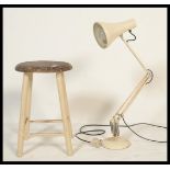 A vintage retro 20th Century Herbert Terry Anglepoise desk lamp raised on a circular base with