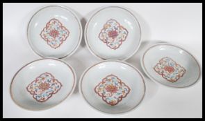 A set of five 20th Century Chinese charger plates having hand painted central floral medallion