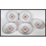 A set of five 20th Century Chinese charger plates having hand painted central floral medallion