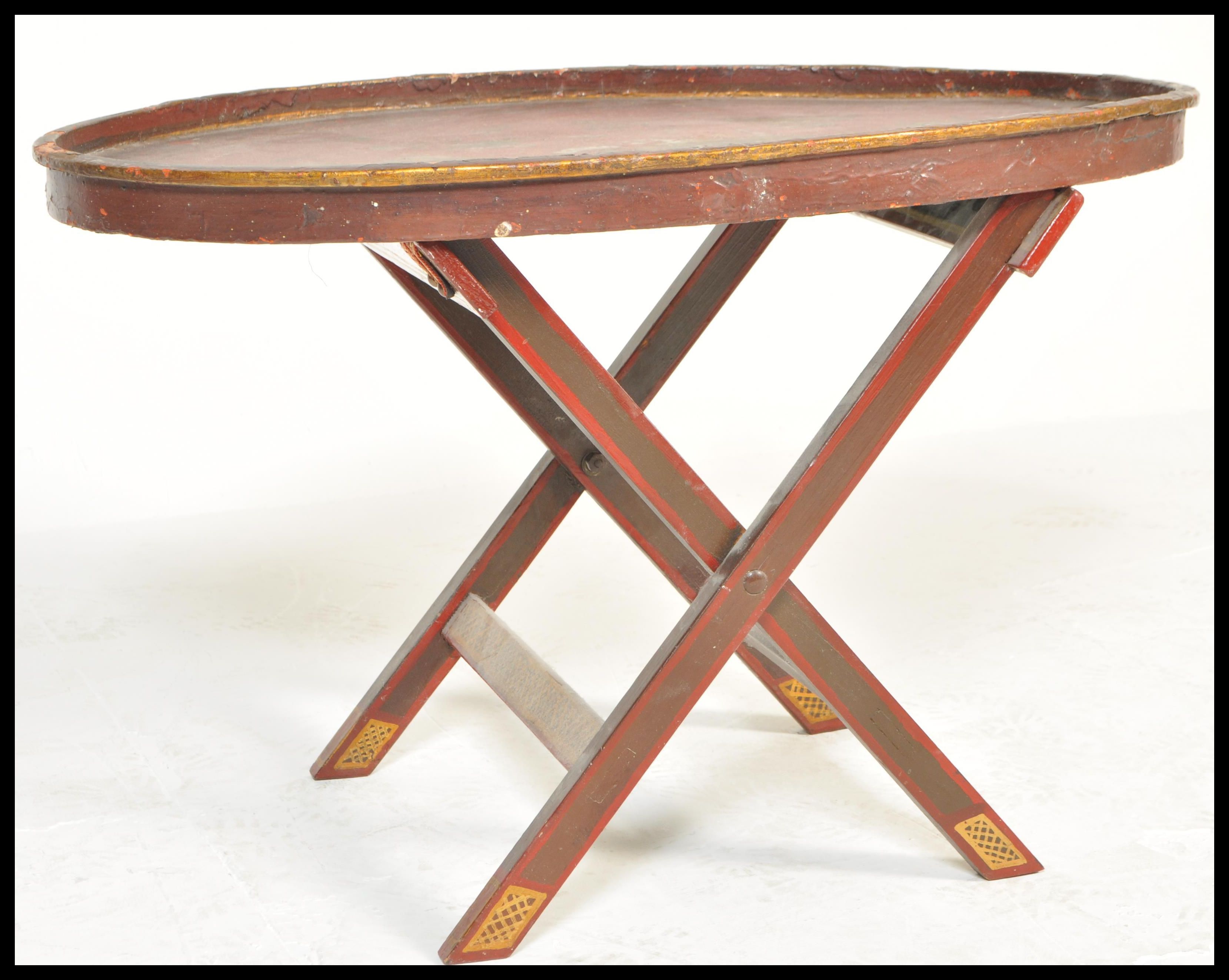 An early 20th Century Japanese lacquered butlers tray on a later stand, the gallery tray having hand