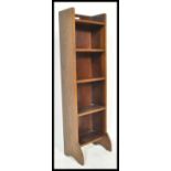 A 19th century Liberty & Co of London open window upright pedestal bookcase. The central shelves
