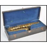 A 20th Century Elkhart saxophone with a gold lacquer finish having mother of pearl keys, set