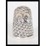 A sterling silver novelty thimble in the form of an owl. Weighs 13 grams.
