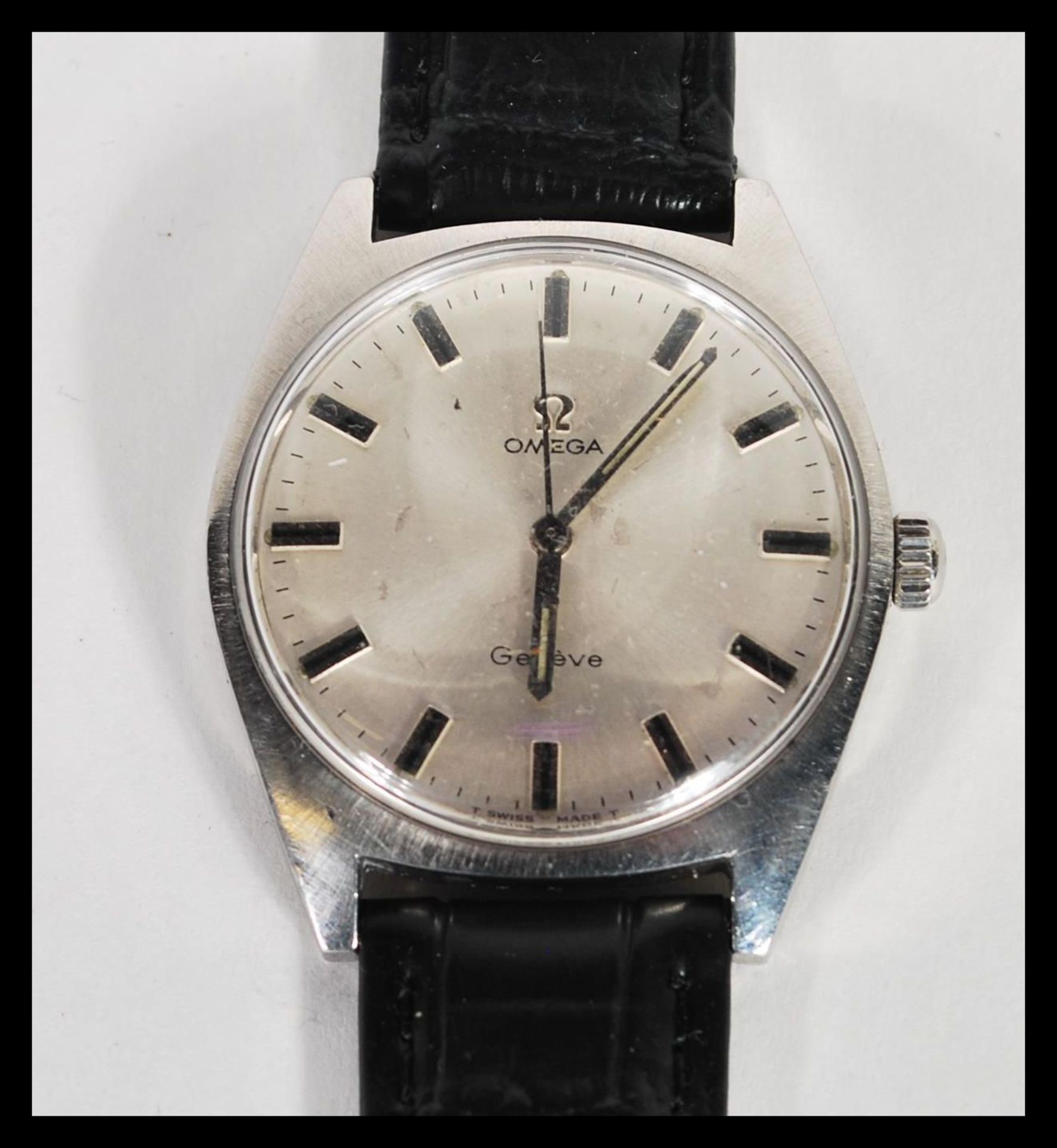 A vintage Omega Geneve waterproof watch having a silvered dial with silver baton numerals and