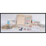 A collection of stamps from around the world contained within a stamp album together with a