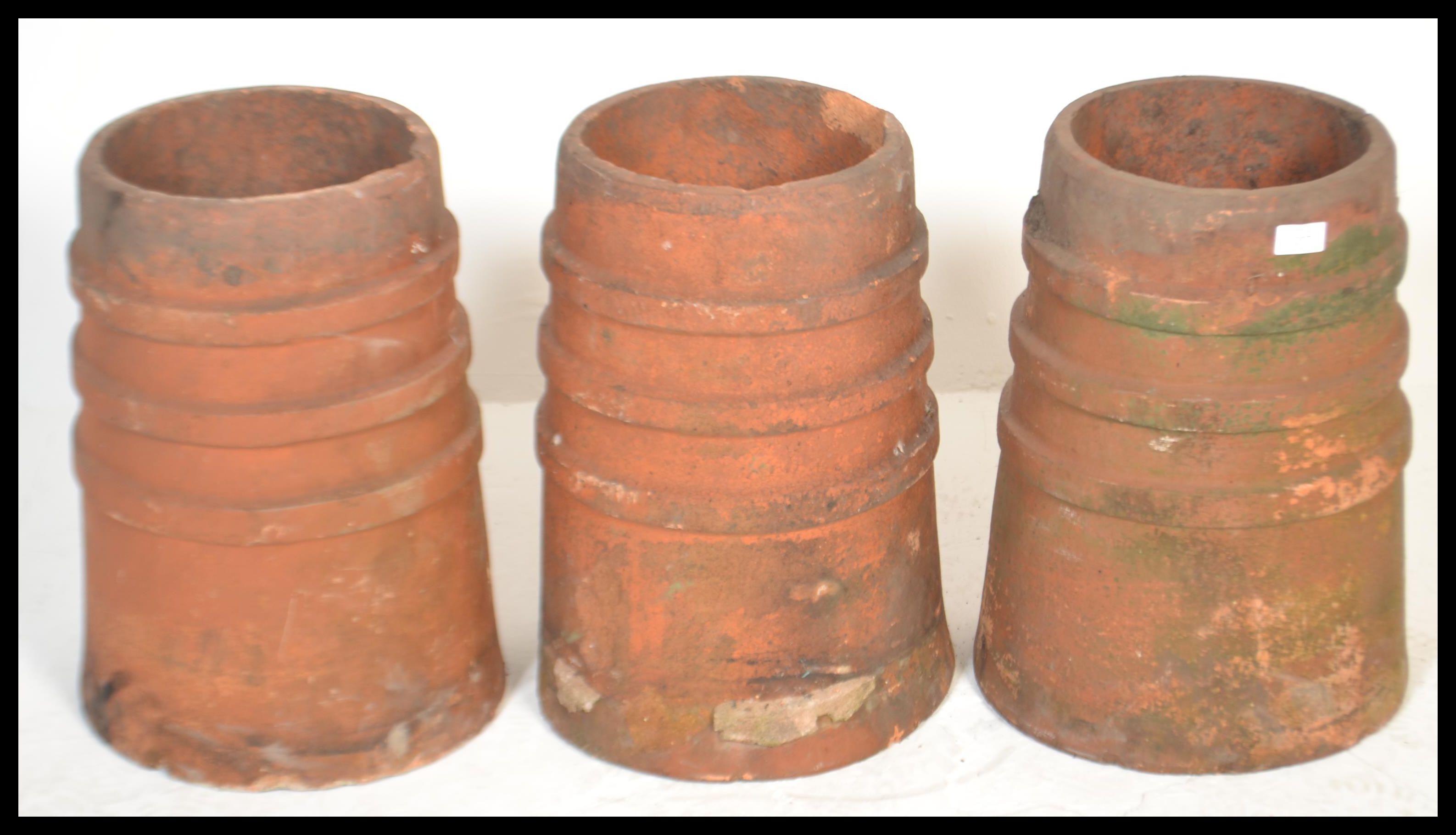 A group of three 20th Century reclaimed stoneware chimney pots of matching cylindrical form. - Image 2 of 5