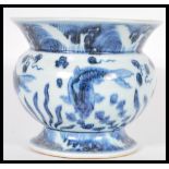 A Chinese 20th Century blue and white hand painted vase raised on a circular base with large bulbous