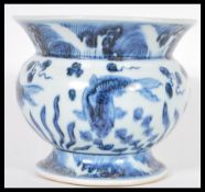 A Chinese 20th Century blue and white hand painted vase raised on a circular base with large bulbous