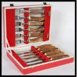 A cased set of Cork & Son cutlery with stainless steel blades and stag horn handles including six