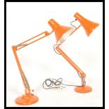 A vintage mid century Herbert Terry Industrial anglepoise desk lamp in an orange colourway