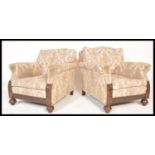 A pair of 1920's Chesterfield armchairs being raised on bun feet with castors having barrel arms and