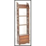 A 19th Century Victorian mahogany whatnot bookcase having a set of four shelves over twin drawer