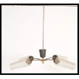 A vintage mid century retro electrolier chandelier having tubular metal form with 3 branches all